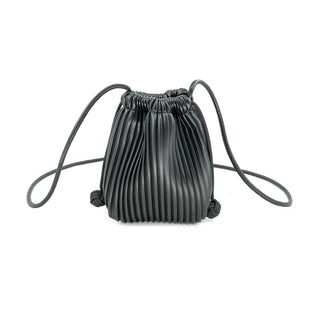 Front view of a sleek, black pleated pouch bag set against a crisp white background. The handbag features a soft, cinched bucket silhouette defined by deep vertical accordion pleats, giving it a highly textured, sculptural appearance. It is detailed with thin, tubular drawstring cords that double as shoulder straps, which cinch the top closed and finish with decorative knotted details near the bottom corners.