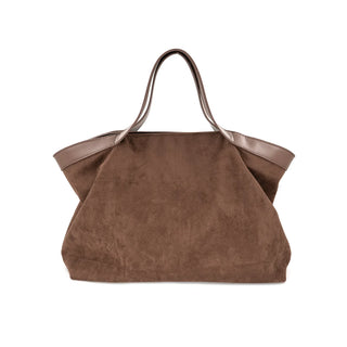 A large, slouchy chocolate brown suede tote bag featuring a wide, winged silhouette. The bag is accented with smooth brown leather-style trim along the top opening and two matching smooth shoulder straps. Displayed on a crisp white background, the handbag showcases a rich textural contrast between the soft, textured suede body and its sleek, structured top edge and handles.