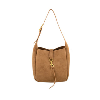 Tan suede shoulder handbag featuring a structured, slouched bucket silhouette with soft, velvety texture against a clean white background. The bag incorporates a central vertical closure strap with a gold-tone dog-clip clasp and an extended leather tassel detail. It includes an adjustable shoulder strap with a gold buckle for versatile, elevated everyday wear.