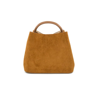 A structured, tan suede tote bag featuring a clean, trapezoidal silhouette that is wider at the base and subtly tapers toward the top. The handbag is accented with two smooth, rigid brown leather-style round top handles, providing a distinct textural contrast against the soft suede body. Displayed on a crisp white background, the image highlights the bag's warm cognac hue, subtle top-stitching detail, and minimalist design.