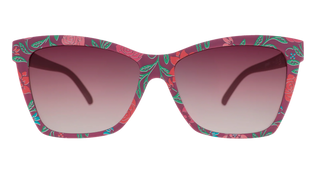 Front view of the Goodr Prairie Mystique Fuschia Fields Forever sunglasses against a transparent background. The eyewear features a classic, subtly rounded square frame with a deep fuchsia base, decorated with a vibrant botanical pattern of pink roses, green leaves, and light blue accents. The lenses feature a matching warm gradient tint, fading from dark pinkish-purple at the top to a lighter, clear hue at the bottom.