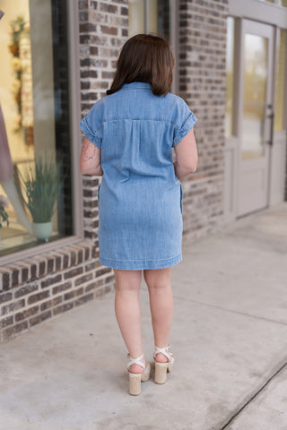 Back view of the Z Supply Napa Mini Dress highlighting the clean lines of the midweight denim blend and the cuffed short sleeves. The lightweight fabric provides a supple drape and a "lived-in" texture, ideal for a casual coastal aesthetic.