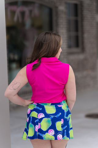 Rear view of the Pink Punch Polo emphasizing the clean, streamlined silhouette and the reinforced stitching of the sleeveless design. The breathable technical fabric provides superior cooling and maximum mobility, making it an ideal choice for tennis or golf.