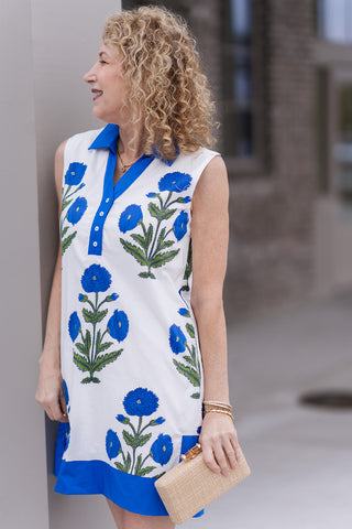 A profile close-up of the Breezy Blue Horizon Dress highlighting the architectural detail of the contrasting royal blue V-neckline and pointed collar. The image showcases the premium quality of the Mediterranean geometric print and the clean-finished armholes of the sleeveless silhouette.