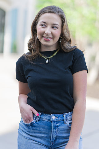 A portrait view of the Z Supply Modern Slub Tee highlighting its premium 100% cotton slub jersey texture. The lightweight, breathable fabric is shown in a true-to-size regular fit with a clean crew neckline. The subtle "slub" weave adds organic depth to the black color, providing an elevated look to a wardrobe staple.