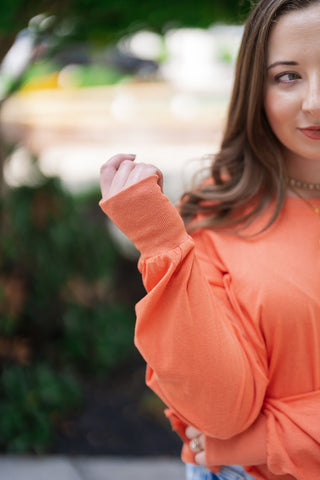 A detailed close-up shot of the Citrus Core Crossover Sweatshirt focusing on the sleeve construction. The image captures the soft fabric texture and slight gathering at the wrist, highlighting the premium, elongated ribbed cuff that gives the sweatshirt its cozy, high-end finish.