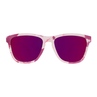 Front-facing view of the Goodr "OMG, I Could Just Dye" sunglasses against a white background. The eyewear features a classic, subtly squared wayfarer-style silhouette with a frame patterned in a vibrant pink and white tie-dye texture. The lenses boast a deep, reflective mirrored magenta finish.